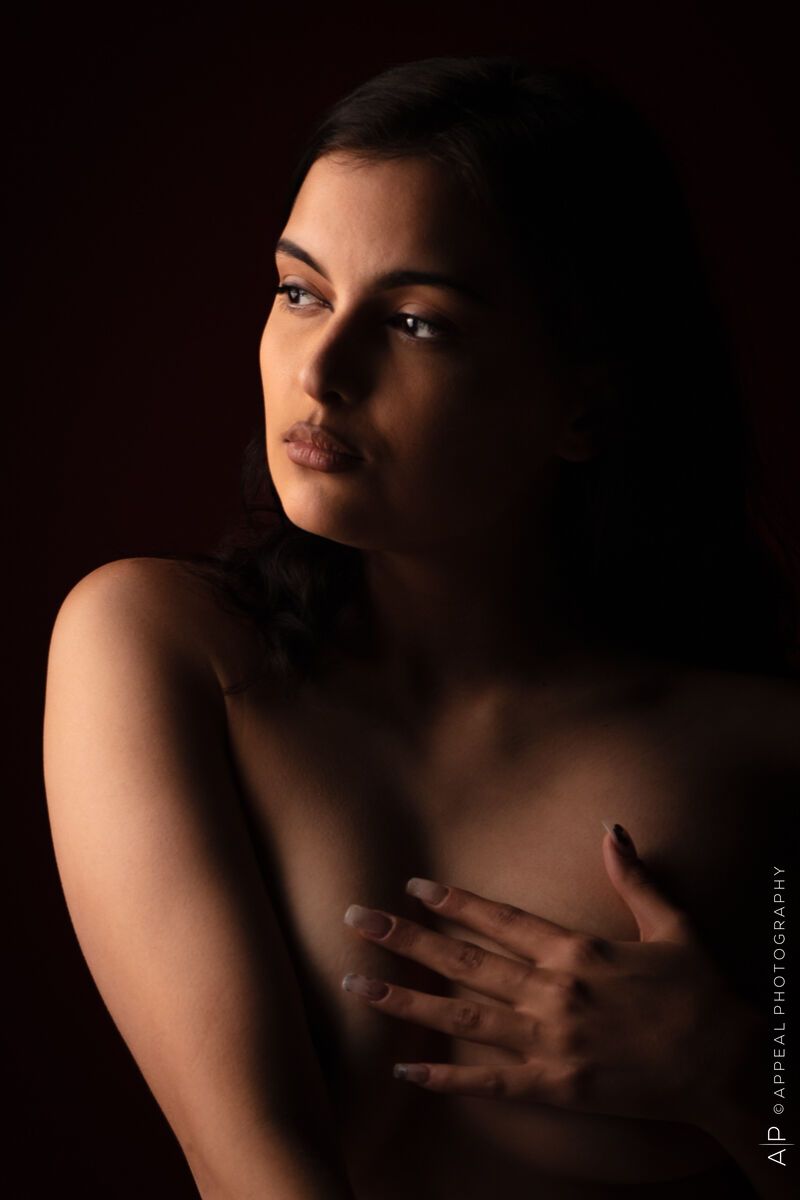 Implied Nude Portrait a woman with her hand on her chest